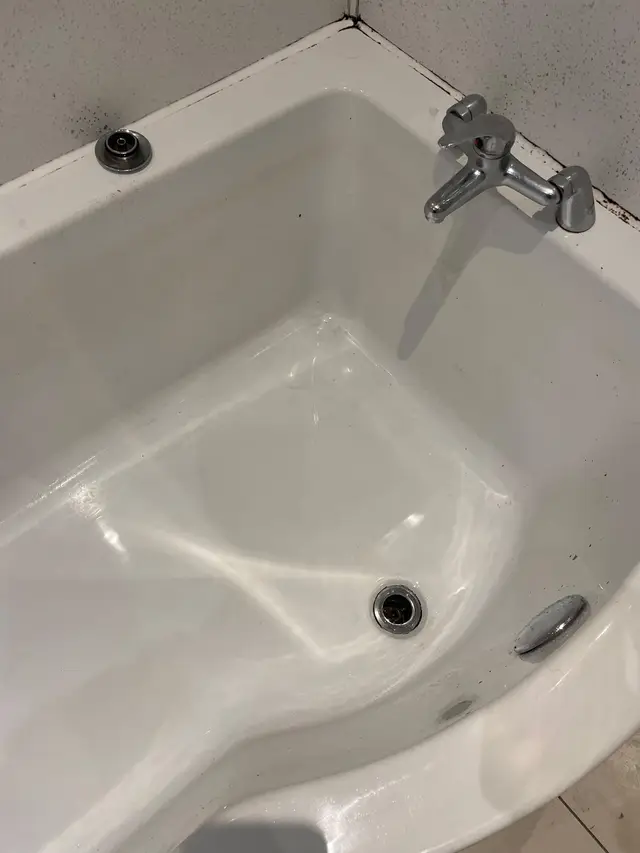 The same bath empty and clean after the blockage was cleared