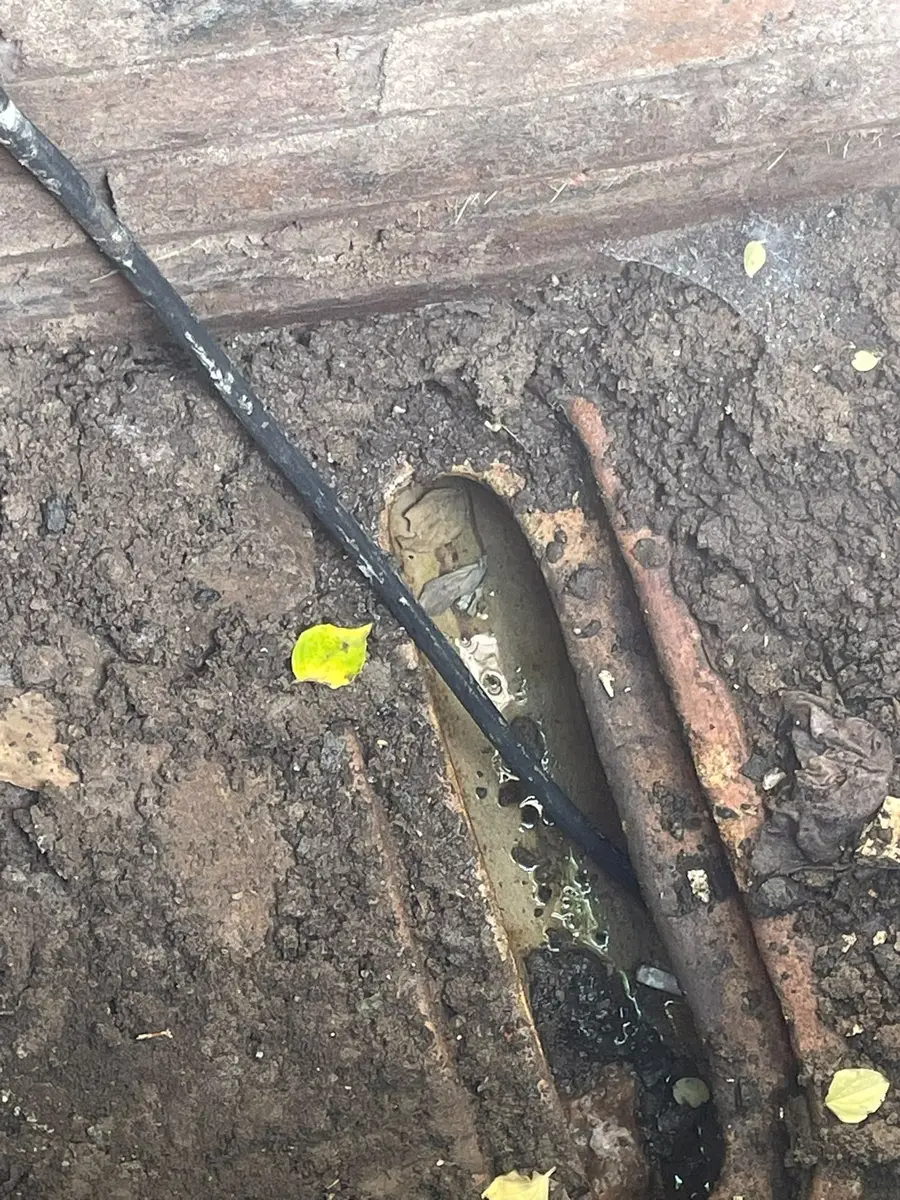 Old underground pipework exposed in an excavation